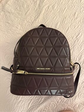 MICHAEL KORS Quilted Backpack in maroon/dark purple with Gold Hardware.
